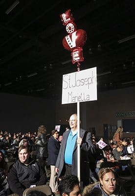 Mark Harding of St. Joseph Church, Marietta, has Valentine’s Day balloons atop his parish sign so members can find their way to the parish’s seating area inside the main hall of the Cobb Galleria Centre, site of the Feb. 14 Rite of Election and the Call to Continuing Conversion. Harding’s wife Christina is the director of the St. Joseph’s RCIA program. Photo by Michael Alexander