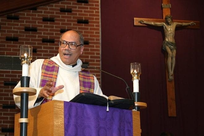 Father Giles Conwill closes out the final evening of a 2004 revival on the theme of reconciliation at Our Lady of Lourdes Church, Atlanta. Father Conwill, a native of Louisville, Ky., was ordained a priest for the Diocese of San Diego, Calif., in 1973. Photo By Michael Alexander