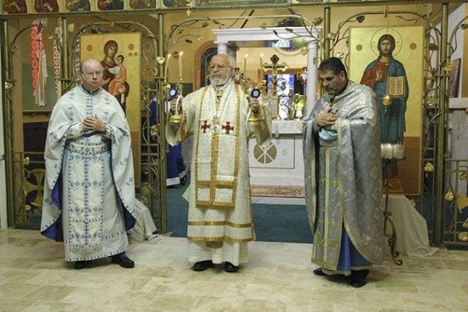 Father Thomas Flynn, left, concelebrates a hierarchical liturgy with Saint John Chrysostom Melkite Church pastor, Father John Azar, right, during a 2006 visit by Archbishop Cyril Salim Bustros, center, Melkite Eparch of Newton. Father Flynn has assisted in the Melkite Catholic community on occasion over the years, a relationship that began some 15 years ago when he befriended the former pastor Father William Haddad. Photo By Michael Alexander