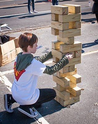 The Middle School Fest provided games galore, including this large stacking game being played by Matthew Murphy, of Prince of Peace Church, Flowery Branch. Photo By Thomas Spink