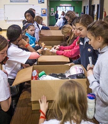Middle school teens packed lotion and soap, among other items, for the archdiocesan Prison Ministry to distribute to people in prison. Photo By Thomas Spink