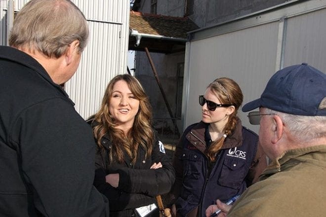 Deacon Steve Swope, left, of St. George Church, Newnan, talks with interpreter Taida Rastic and Erin Mackey, right, of Catholic Relief Services in Serbia, near the Croatian border. Deacon Swope and Deacon Bill Hampton of Tyrone were part of a CRS delegation visiting Greece and Serbia in January to learn about the needs of refugees. Translation services are part of what CRS offers to help families make informed decisions about where and how to seek asylum. Photo By Mikaele Sansone/Catholic Relief Services
