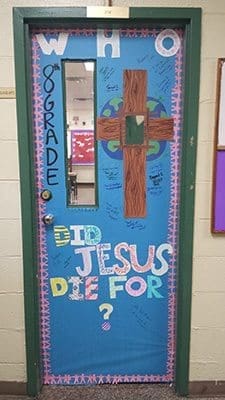 This door at St. Peter Claver Regional School, Decatur, was created by eighth-graders. It took first place in a school contest tied to the Year of Mercy by showing the relationship between each person and the cross.
