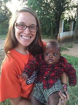 Anne Krier holds a baby on her mission trip with To the Nations in 2015 to Uganda. A parishioner of St. Francis of Assisi in Blairsville, Krier will return to Uganda this summer.