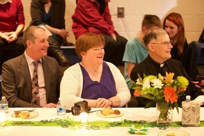 Msgr. Fogarty’s nephew, P.J. Fogarty, left, and his wife, Mary Joyce, were surprise guests from Ireland along with his nephew and godson, Seamus Fogarty. Photo By Dave Dawson