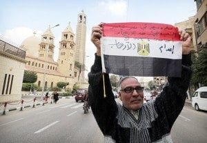 A man in Cairo Feb. 16 denounces the killing of Egyptian Christians in Libya. U.S. Secretary of State John Kerry said atrocities carried out by the Islamic State group against Yezidis, Christians and other minorities were genocide, the first U.S. declaration of genocide since Sudanese actions in Darfur in 2004. CNS photo/Khaled Elfiqi, EPA