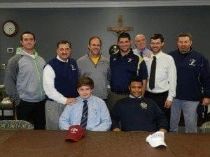 Front row (l-r) Chad Nelson and Chris Benjamin signed to play football with Elon University, Elon, N.C., and Brevard College, Brevard, N.C., respectively. Standing behind them are (l-r) assistant coach Jason Tester, head coach Paul Standard, athletic trainer Gary Schmitt, assistant coach Michael Hatter, athletic director Mark Kelly, and assistant coaches Todd Stewart and Chad Garrison.