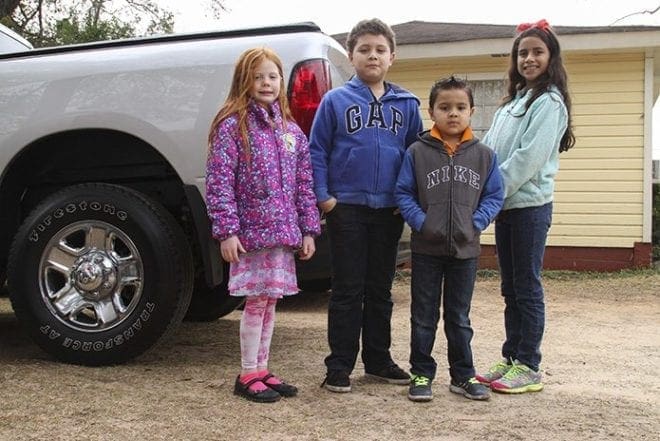 Moments before this photo, El Refugio guests (l-r) Hailee Norton of Rome, 6, Jafet Martinez of Queens, N.Y., 9, his brother Jared, 5, and his sister Brianna, 8, were running around and playing in the yard. At that moment the issue that briefly brought them together was either unspoken or incomprehensible, for they were merely conducting themselves as innocent children. Photo By Michael Alexander