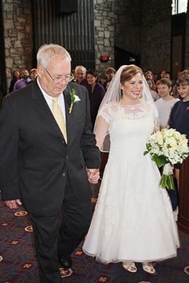 Lawrence Ross escorts his daughter, Beth Anne, down the aisle for her April 1 wedding at St. Jude the Apostle Church, Atlanta. The entire student body of the school, many of whom had previously had Ross as a teacher, attended the ceremony. Photo By Katy Cowan