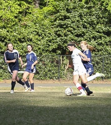 Holy Spirit Preparatory School junior forward Allie Bertany, second from the right, attempts a goal in the second half of the April 18 soccer match against Griffin Christian High School. Bertany, the team’s leading scorer and the school’s single season record holder with 30 goals, was held scoreless, which broke her 16-game scoring streak. Holy Spirit still prevailed 4-0. Photo By Michael Alexander