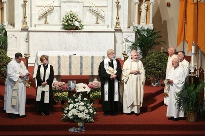 After the prayer of commendation, (clockwise, from left) the Shrine of the Immaculate Conception’s Deacon Dom Saulino, former Central Presbyterian Church associate pastor Caroline Kelly, Central Presbyterian Church pastor Gary Charles, Shrine pastor Msgr. Henry Gracz, former Shrine pastor Father John Adamski, the Shrine’s Deacon Bill Payne and Father Steven Yander, a friend of Bashor since 1990, stand by as the Shrine and Central Presbyterian choirs sing “The Irish Blessing.” Photo By Michael Alexander