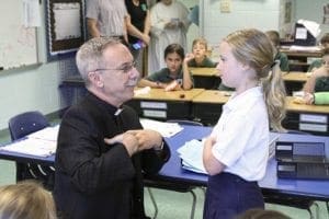 When Mackenzie Yekich, right, asked Bishop Zarama to pray for her deceased grandfather, he said it was perfectly okay for her to also pray for her grandfather, and to ask him to pray for her. The bishop shared how he calls on his late father to pray for him as he does the work of the Catholic Church for the Archdiocese of Atlanta. Photo By Michael Alexander