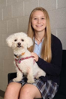 With all the extracurricular activities Krunkosky participated in, Monsignor Donovan High School senior Rachel Krunkosky found time for community service like volunteering at the Athens Area Humane Society. Krunkosky was inspired by her older sister and their father, a veterinarian and associate professor at UGA’s College of Veterinary Medicine. Here Krunkosky poses with the family dog Dessi, a bichon poodle. Photo By Michael Alexander