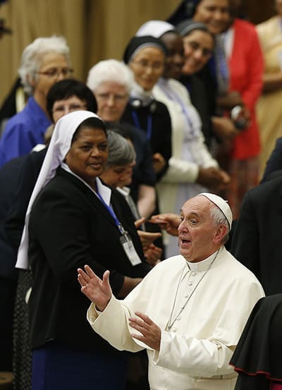 Pope Francis gestures during an audience with the heads of women's religious orders in Paul VI hall at the Vatican May 12. During a question-and-answer session with members of the IUSG, the pope said he was willing to establish a commission to study whether women could serve as deacons. CNS Photo/Paul Haring