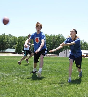 Zayne Rice, left, plays defense against his sister Madison as they practice flag football for her team’s participation in the annual Special Olympics Georgia state summer games May 20-22 at Emory University. Zayne has helped out as a Special Olympics buddy in Forsyth County since he was 8-years-old. Photo By Michael Alexander