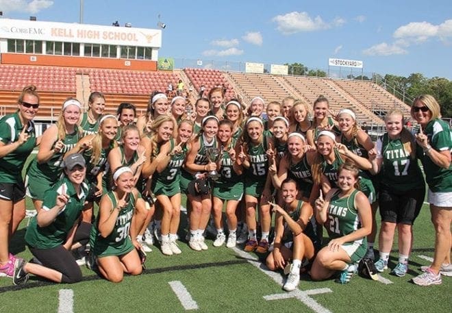 Blessed Trinity High School girls head coach Elizabeth McFarland, far right, and her team captured the school’s first state championship in lacrosse last month. The team also went undefeated during the season.