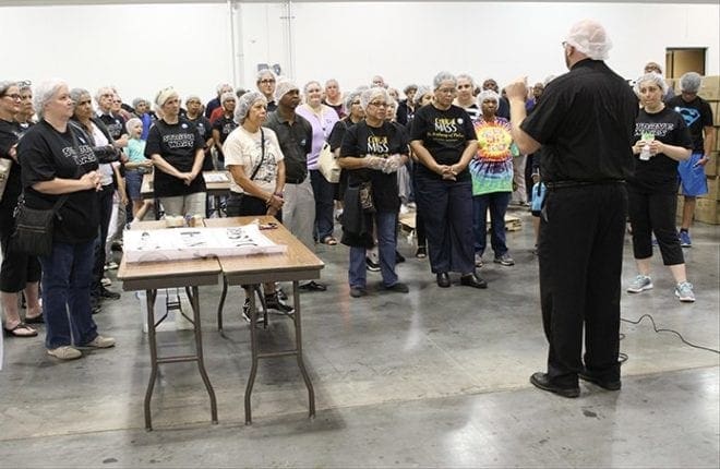 Father Victor Galier, foreground right, pastor of St. Anthony of Padua Church, Atlanta, fills Starve Wars participants in on the work of Catholic Relief Services (CRS) and how their volunteer efforts will benefit the people of West Africa’s Burkina Faso. Father Galier has been a CRS fellow ambassador educator since 1997. Photo By Michael Alexander