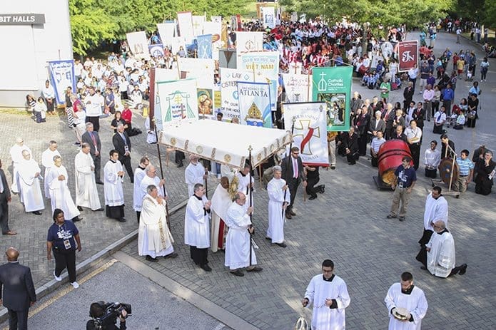 Archbishop Wilton D. Gregory processes with the Blessed Sacrament in front of the thousands of Eucharistic Congress participants who will follow behind him during the outdoor morning procession to the interior of the Georgia International Convention Center, College Park June 4. Photo By Michael Alexander