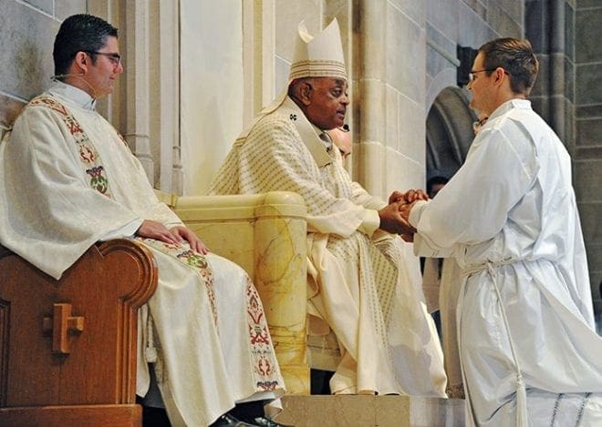 Brian McNavish pledges his obedience to Archbishop Wilton D. Gregory and his successors during his ordination to the transitional diaconate. Photo By Lee Depkin
