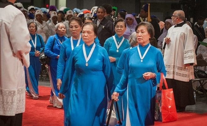 Parishioners of Our Lady of Vietnam Church, Riverdale, participate in the opening procession at the Eucharistic Congress June 4. Photo By Thomas Spink