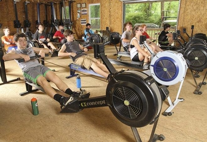 Middle school athletes work out on the ergometer, sometimes known as an ergo or erg machine. In addition to being a conditioning tool, the machine simulates actual rowing strokes and it allows the athletes to go through different parts of strokes at various increments. Photo By Michael Alexander