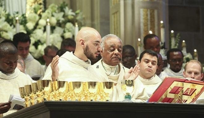 Father Carlos Cifuentes reads from the eucharistic prayer for the first time as a new priest. Father Cifuentes’ first assignment is parochial vicar at Prince of Peace Church, Flowery Branch. Photo By Michael Alexander