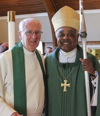 Archbishop Wilton D. Gregory, right, celebrated the Mass for Father Frank Richardson’s retirement. He thanked the priest for being a mentor in helping young priests learn to become good shepherds. Photo By David John Torrento Photography