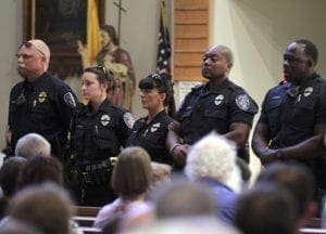 Police officers attend a July 17 vigil at St. John the Baptist Church in Zachary, La., for the fatal attack on policemen in Baton Rouge, La. A former Marine dressed in black shot and killed three Baton Rouge law enforcement officers that day, less than two weeks after a black man was fatally shot by police here in a confrontation that sparked nightly protests nationwide. CNS photo/Jeffrey Dubinsky, Reuters