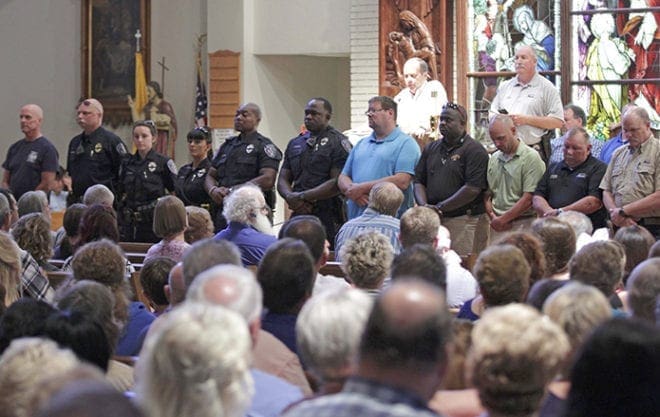 Police officers attend a July 17 vigil at St. John the Baptist Church in Zachary, La., for the fatal attack on policemen in Baton Rouge, La. A task force of U.S. bishops has been appointed to help them address racial issues following a series of summertime shootings that left both citizens and police officers among the dead. CNS Photo/Jeffrey Dubinsky, Reuters