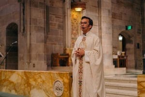 Father Tri Nguyen, parochial vicar at St. Brigid Church, Johns Creek, was the homilist for the July 13 World Youth Day pilgrims Mass at the Cathedral of Christ the King, Atlanta. He encouraged pilgrims to be patient and be open to experiences awaiting them in Poland. Photo By Bau Nguyen