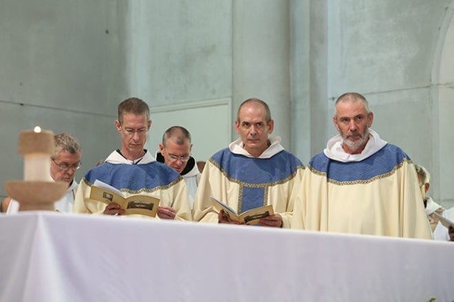 Abbot-elect Augustine Myslinski, OCSO, center, is assisted during the Aug. 15 abbatial blessing at the Monastery of the Holy Spirit, Conyers, by Abbot Elias Dietz, OCSO, left, of Our Lady of Gethsemani Abbey, Trappist, Ky., and Conyers Abbot-emeritus Francis Michael Stiteler, OCSO, right. Photo By Michael Alexander