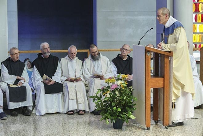 The new abbot Dom Augustine Myslinski, OCSO, standing right, shares some thoughts and expresses his gratitude to the congregation and those on the altar. Listening to the side are some of his brother monks, including (l-r) Brother Alan Jurusik, OCSO, Brother Hugh Vanasse, OCSO, Father Tom Francis Smith, OCSO, Father Gerard Gross, OCSO, and Brother Elias Marechal, OCSO. Photo By Michael Alexander