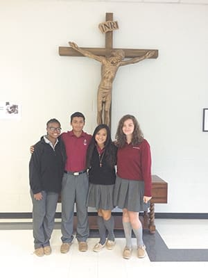 The Christian Outreach Class at Our Lady of Mercy High School, Fayetteville, planned a prayer service with Scripture, remembrance of 9/11, heroic acts by Christians and prayers for peace. Shown, left to right, are student leaders Vanessa Smith, Aldahir Barrantes, Thao Tran and Natalie Main.