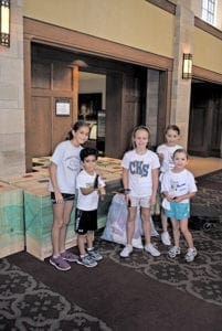 Christ the King School students participate in the school’s first Family Day of Service. They built and filled dressers with clothing for refugee children being assisted by Catholic Charities Atlanta.