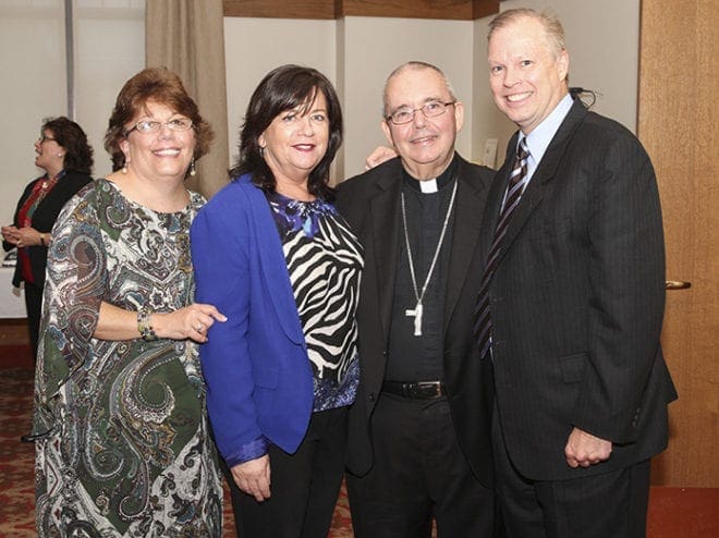 Bishop David Talley, second from right, stands with (l-r) Joan Tobia, Alice Hill and Jeff Jetton. The trio from St. Jude the Apostle Church, Atlanta, met Bishop Talley during his first assignment as a parochial vicar at their parish in 1989. They were members of the parish singles group, Catholic Singles Together. He was the chaplain for the group. Photo By Michael Alexander