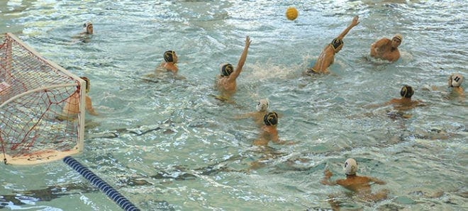 St. Pius X’s Jordan Chatfield, top right, scores the team’s third goal from 30 feet out with 57 seconds left in the first half of the championship match against Peachtree City’s Southern Crescent Aquatic Team. Photo By Michael Alexander