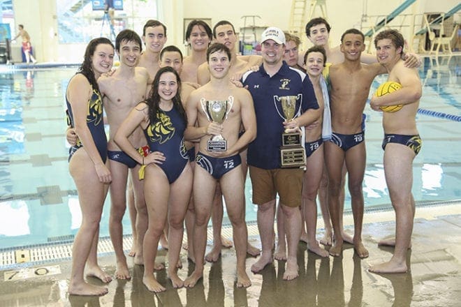 Members of the St. Pius X Georgia High School Water Polo Association state championship team stand with head coach Michael Peters, sixth from the right. At the conclusion of the 2016 GHSWPA tournament, the team picked up a state championship trophy and a trophy for the team with the best regular season record. Their regular season record was 12-0. Photo By Michael Alexander
