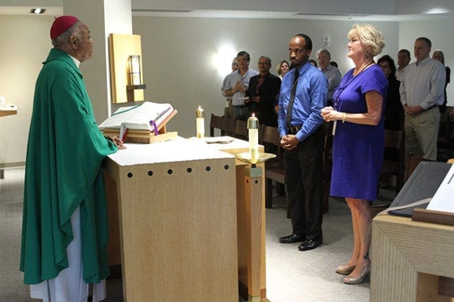 Ashley Morris and Kathy Montag receive a blessing from Archbishop Wilton D. Gregory before they head off for a Sept. 7 Catholic Relief Services delegation visit to Rwanda. Photo By Michael Alexander
