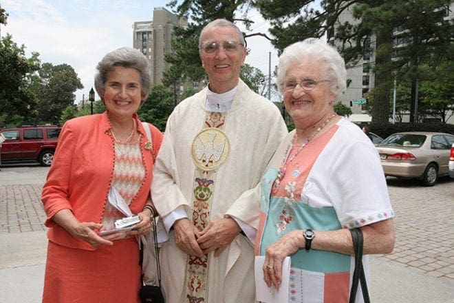 Father Edward O’Connor, center, joins Rosemary Crockette, left, and Mary Hibbard of St. Theresa of the Child Jesus Church, Douglasville, for a photo on the Cathedral of Christ the King plaza after the May 2010 Jubilarian Mass. Father O'Connor, who was the founding pastor of St. Theresa, celebrated his 50th anniversary as a priest that year. Photo By Michael Alexander