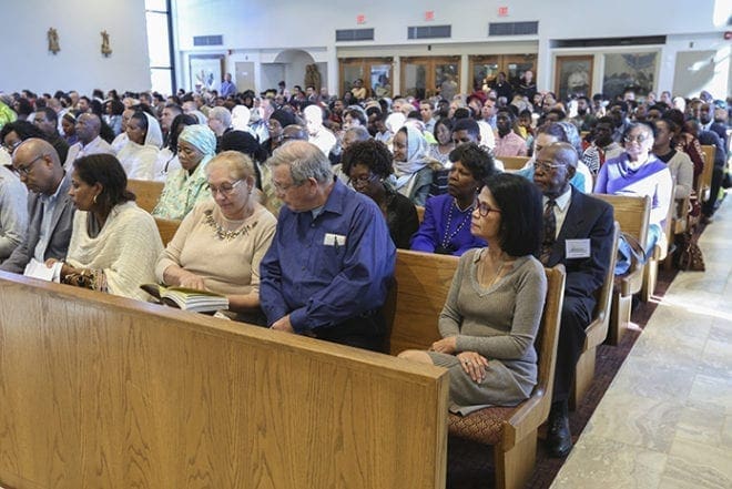 The congregation at Corpus Christi Church, Stone Mountain, fills the refurbished church on the day of its rededication Mass last month. The parish of 1,200 families is made up of people from nearly 60 different countries from around the world. Photo By Michael Alexander