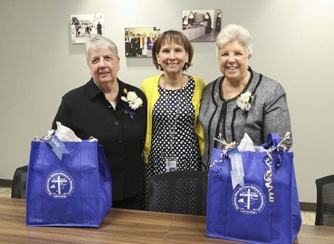 St. John the Evangelist School principal Karen Vogtner, center, stands with Sisters of Mercy Sally Condart, left and Kathleen Lyons inside the school’s newly blessed and dedicated Mercy Conference Room. Sister Sally was the school principal from 1976-1979 and Sister Kathleen was the director of religious education from 1972-1980. They currently reside in the Philadelphia area. Photo By Michael Alexander