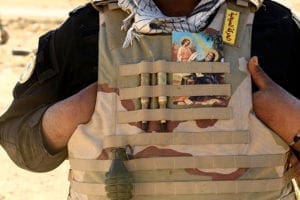 A Christian fighter displays a holy card in his vest Nov. 21 in Mosul, Iraq. As Christians in the Middle East look back on 2016, they wonder if there will be much to celebrate amid mounting challenges, particularly for those displaced by conflicts in Iraq and Syria. CNS photo/Thaier Al-Sudan, Reuters 