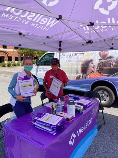 Photo of Anne Brigito and Margaret Pope-Diggs, from left, were volunteers from Transfiguration Church, serving at the April 20 vaccine clinic in Marietta.