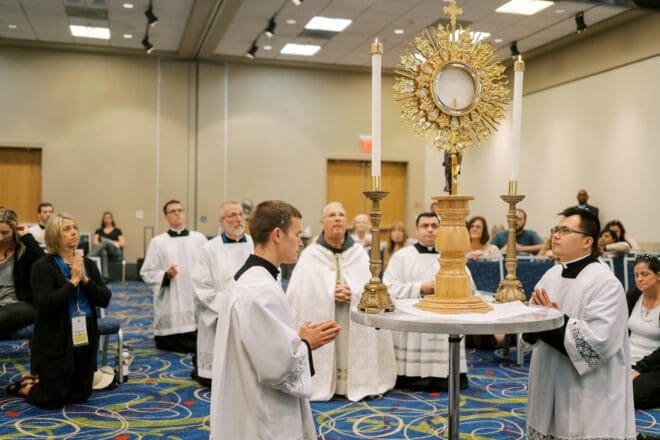 Participants in the American Sign Language Track at Atlanta’s Eucharistic Congress join Archbishop Hartmayer in prayer before the Blessed Sacrament June 18. There was also an on-site adoration chapel at the Congress. Photo by Christine Clements