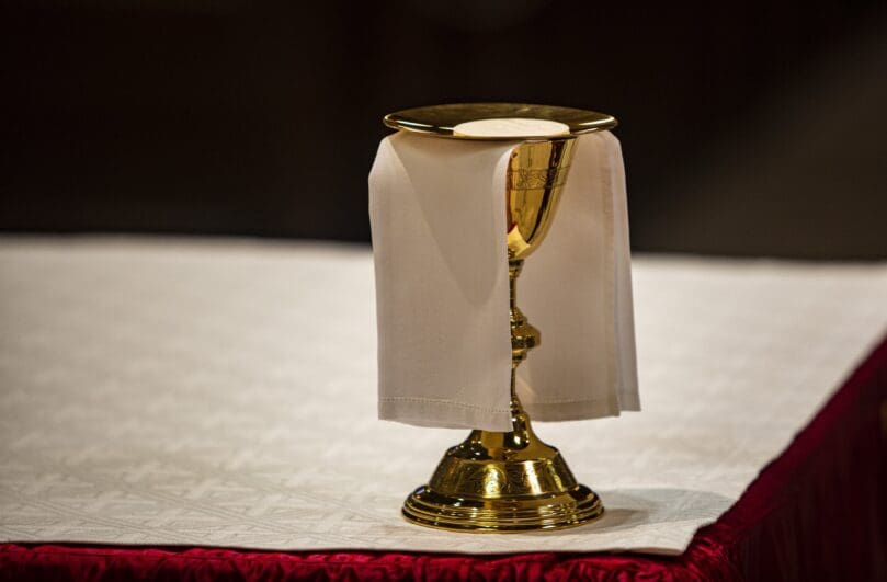 The Eucharist rests on a paten on the altar in the Cathedral of St. Peter in Wilmington, Delaware. CNS photo/Chaz Muth