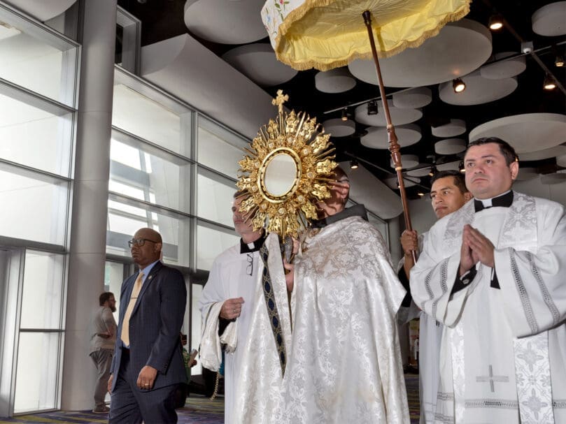 Archbishop Gregory J. Hartmayer, OFM Conv., carries the Blessed Sacrament at a morning procession of the 25th Eucharistic Congress in June 2022.