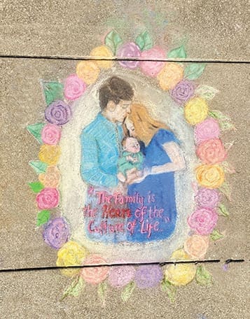 A family with a young child depicted in sidewalk chalk won first place in a national contest for Holy Spirit Prep students.
