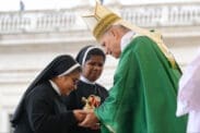 Pope Leo XIV accepts the offertory gifts from two religious sisters during Mass for the Jubilee of Migrants and the Jubilee of the Missions in St. Peter’s Square at the Vatican Oct. 5.