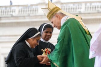 Pope Leo XIV accepts the offertory gifts from two religious sisters during Mass for the Jubilee of Migrants and the Jubilee of the Missions in St. Peter’s Square at the Vatican Oct. 5.