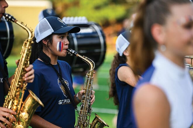 Saxophone musician on the field during the middle school fall festival at St. Pius X High School.
